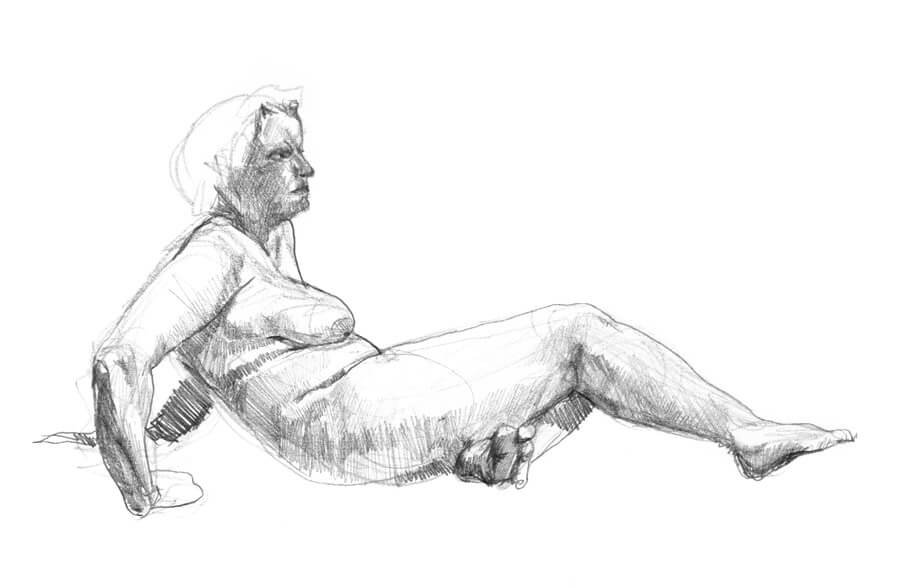 Female model laying down with her arms behind her bracing herself