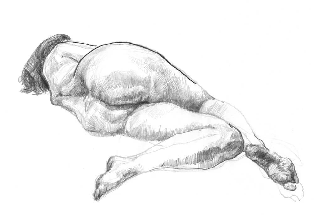 Female model laying on her side with her legs folded positioned away from the viewer