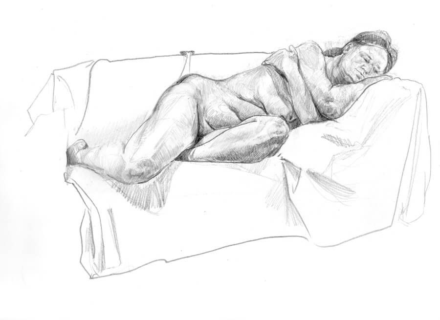 Female model laying on a couch with her arms crossed